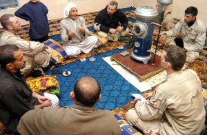 Capt. Jeramy Hopkins (bottom right), civil military operations officer for TF 1-27 Inf., and Maj. David Ford (top center), a team leader with Provisional Co. A, 385th CA Bde., listen to the muqtar of Sudayera (to the left of Ford) during a meeting about future reconstruction projects in the area on Jan. 22. (Sgt. Sean Kimmons)